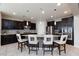 Spacious kitchen with dark cabinetry, large island, and stainless steel appliances at 329 Rezzo St, Las Vegas, NV 89138