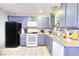 Galley kitchen with granite countertops and gray cabinets at 4145 Plumtree St, Las Vegas, NV 89115