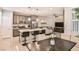 Modern kitchen with island, stainless steel appliances, and gray cabinets at 4537 Cloudrest Peak St, North Las Vegas, NV 89031