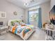 Bright bedroom with a full-size bed, colorful bedding, and a large window at 5 Clear Crossing Trl, Henderson, NV 89052