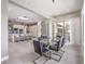 Elegant dining room with glass table, modern chandelier, and access to the kitchen at 5 Clear Crossing Trl, Henderson, NV 89052