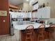 Galley-style kitchen with white cabinets and a breakfast bar at 5900 Ablette Ave, Las Vegas, NV 89122