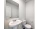 Simple bathroom with pedestal sink and toilet at 6152 Violet Falls St # 47, North Las Vegas, NV 89081