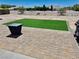 Artificial turf backyard with paver patio and fire pit at 681 Indian Wells Ct, Pahrump, NV 89060