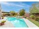 Inviting pool and spa surrounded by a lush, landscaped yard at 7306 Puckershire St, Las Vegas, NV 89166