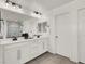 Double vanity bathroom with modern white cabinets at 7450 Tinley Creek Ave, Las Vegas, NV 89113