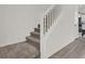 Modern staircase with carpeted steps and white railing at 7450 Tinley Creek Ave, Las Vegas, NV 89113