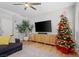 Living room with sectional sofa, fireplace, and Christmas tree at 8715 Villa Ariel Ln, Las Vegas, NV 89147