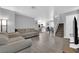 Open living room with gray walls, stairs, and kitchen view at 10068 Crisp Clover St, Las Vegas, NV 89183