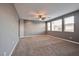 Main bedroom with large windows and carpet flooring at 10148 Rockridge Peak Ave, Las Vegas, NV 89166