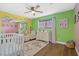 Bright Bedroom features colorful walls, crib, and comfortable seating at 1589 Raindance Way, Las Vegas, NV 89169