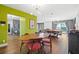 Bright dining area with mid-century modern table and chairs, open to the living room and game room at 1589 Raindance Way, Las Vegas, NV 89169