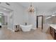 Bathroom with a large soaking tub and chandelier at 1700 Saint Gregory Dr, Las Vegas, NV 89117