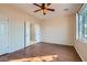 Bright bedroom with wood floors, ceiling fan, and en-suite bathroom at 2347 Tranquil Moon St, Henderson, NV 89044