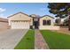 Single-story house with a two-car garage and landscaped front yard at 2374 Amana Dr, Henderson, NV 89044