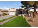 Single story home with brick walkway, two-car garage and landscaped lawn at 2374 Amana Dr, Henderson, NV 89044