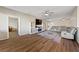 Spacious living room with gray sectional sofa and wood-look floors at 2374 Amana Dr, Henderson, NV 89044