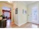 Hallway with wood-look flooring, decorative etched glass door, and view to adjacent room at 2400 Wisconsin Dells Dr, Henderson, NV 89044