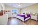 Large main bedroom with purple bedding, white furniture, ceiling fan, and shuttered window at 2400 Wisconsin Dells Dr, Henderson, NV 89044