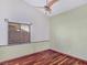 Bedroom with wood floors, ceiling fan, and green accent wall at 3005 Fern Hollow Ct, Las Vegas, NV 89108