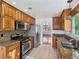 Modern kitchen with granite countertops, stainless steel appliances, and wood cabinets at 3005 Fern Hollow Ct, Las Vegas, NV 89108