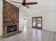 Living room with stone fireplace and tile floors at 3005 Fern Hollow Ct, Las Vegas, NV 89108