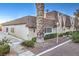 Tan colored exterior of house with mature palm tree and walkway at 3423 Garden East Dr, Las Vegas, NV 89121