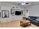 Spacious living room with hardwood floors and black leather sofas at 4690 E Utah Ave, Las Vegas, NV 89104