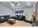 Living room with hardwood floors, leather couches, and a ceiling fan at 4690 E Utah Ave, Las Vegas, NV 89104