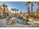 Resort-style pool with a rock waterfall and slide at 4775 N Grand Canyon Dr, Las Vegas, NV 89129