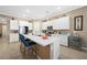 Modern kitchen with white cabinets, large island, and stainless steel appliances at 688 Sunray Park St, Henderson, NV 89011