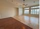 Large living area with tile and hardwood flooring, ceiling fan and large windows at 8616 Willow Cabin St, Las Vegas, NV 89131