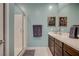 Double vanity bathroom with shower and wood cabinets at 965 Nevada State Dr # 43101, Henderson, NV 89002