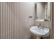 Powder room with pedestal sink and vertical striped wallpaper at 2 Via Siena Pl, Henderson, NV 89011