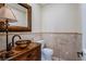 Powder room with pedestal sink and decorative mirror at 2 Via Siena Pl, Henderson, NV 89011