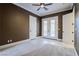 Spacious bedroom with french doors and ceiling fan at 2 Via Siena Pl, Henderson, NV 89011