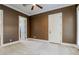 Bedroom with dark brown walls, ceiling fan and access to hallway at 2 Via Siena Pl, Henderson, NV 89011