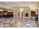 Open concept living room with fireplace, view of the kitchen and access to other areas at 2 Via Siena Pl, Henderson, NV 89011