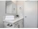 Modern bathroom with white cabinets, quartz countertop, and a large mirror at 2384 Wild Ginger Ln, Las Vegas, NV 89134