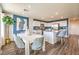 Dining area with white table and blue chairs, adjacent to kitchen at 3474 La Cura Ave # Lot 63, Las Vegas, NV 89141