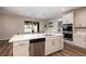 Modern kitchen with island, stainless steel appliances, and white cabinets at 391 American Dipper St, Las Vegas, NV 89138