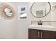 Updated bathroom with a modern vanity and a round mirror at 4761 Lake Pl, Las Vegas, NV 89147