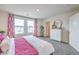 Spacious main bedroom with king bed, white dresser and pink accents at 4836 Currant Ridge Ave # 70, Las Vegas, NV 89141