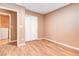 Bedroom with wood-look floors, closets, and laundry access at 6608 Wind Whisper St, Las Vegas, NV 89148