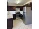 Kitchen with dark cabinets and stainless steel appliances at 696 Anne Ln # 696, Henderson, NV 89015