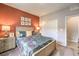 Bedroom with floral comforter and a double door closet at 7639 Phoenix Falls St # Lot 40, North Las Vegas, NV 89084