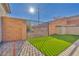 Backyard access with a metal gate and artificial turf at 10590 Sturdevant Ct, Las Vegas, NV 89166