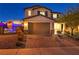 Two-story house with tan garage and brick driveway at 10590 Sturdevant Ct, Las Vegas, NV 89166