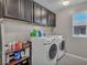 Laundry room with washer, dryer, and cabinets at 10590 Sturdevant Ct, Las Vegas, NV 89166