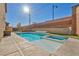 Relaxing pool and spa combo with a sun shelf and tiled coping at 10590 Sturdevant Ct, Las Vegas, NV 89166